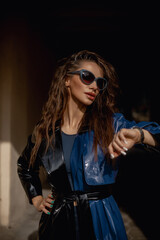 Close-up lifestyle fashion portrait of young hipster woman walking at park , travel with backpack, stylish casual outfit, evening sunset, reflecting sunglasses student, bright make up bf hairstyle