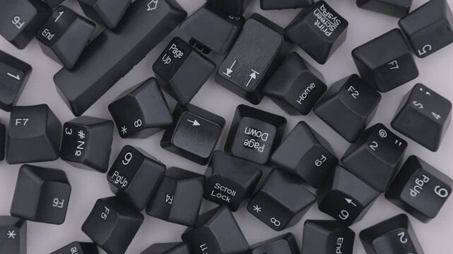 Black keyboard  keycaps rotates on white backgrond. View from above.