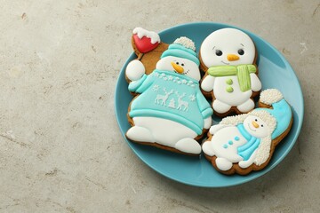 Delicious cookies in shape of snowmen on light grey table. Space for text