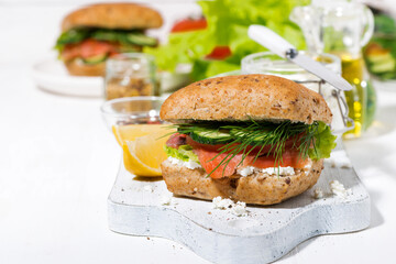 sandwich with salted fish, fresh vegetebles and cream cheese on white board