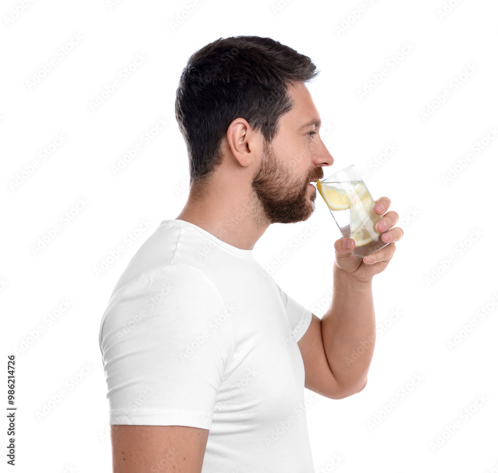 Poster Handsome man drinking water with lemon on white background