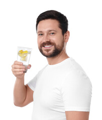 Happy man holding glass of water with lemon on white background