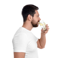 Fototapeta premium Handsome man drinking water with lemon on white background