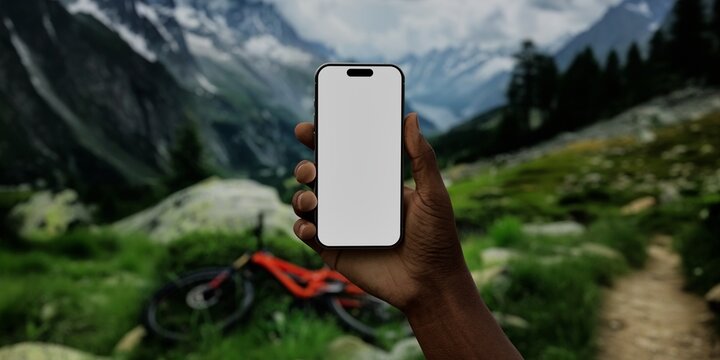 Black African-American male using smartphone with a blank white screen. Mountain bike, alpine landscape, mountain trail apps mockup. Vertical phone orientation - Powered by Adobe