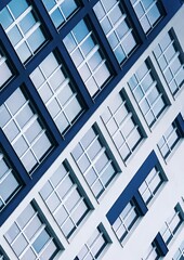 Minimal Architecture Background. Detail New blue high-rise Building or House Modern facade background with glass windows. Contemporary geometrical architectural business vertical design backdrop.