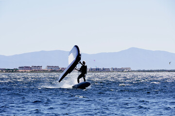Man practices wingfoil in the Mediterranean Sea.