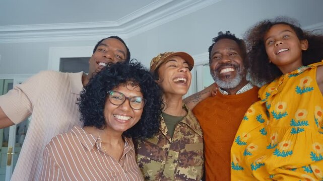 Cinematic video of a woman coming back home from the army military service in the us. Family reunited at lunch time indoor in a beautiful american house.
