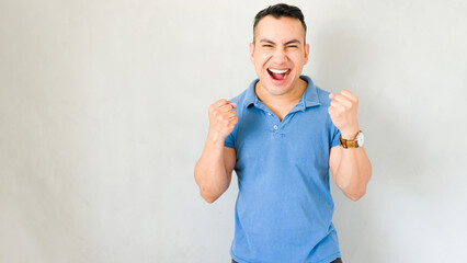 Man in a state of euphoria raises his fists in triumphant celebration