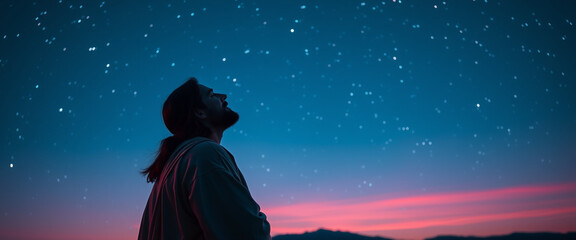 Dark blue starry sky with silhouette of Jesus Christ in desert