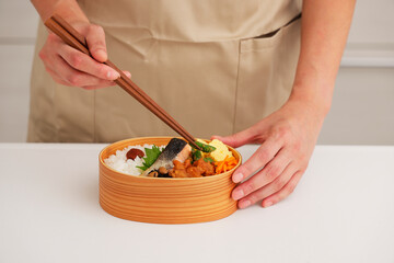 お母さんがキッチンでお弁当を作るシーン