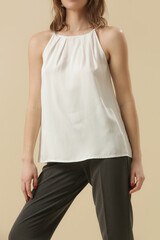 Obraz premium Female model wearing white summer shirt and smart casual black tousers. Fashion studio shot.