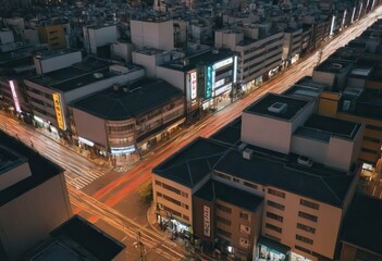 Aerial view of a city at night with a hotel sign