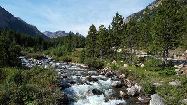 Rock Creek as seen by an aerial camera near the Absaroka-Beartooth Wilderness in southern Montana. Camera travels upstream then climbs above the water revealing the valley. With sound.