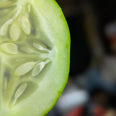 close up of cucumber slices on a wooden cutting board