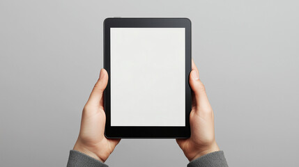 image shows a tablet mockup being held by two hands, with a blank white screen, providing a space for design or content insertion.