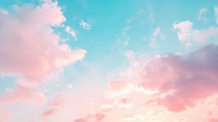 Delicate blue and pink pastel sky with light clouds as the sun sets