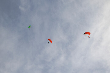 Tandem paraglider pilots with a slightly cloudy sky in Illertissen