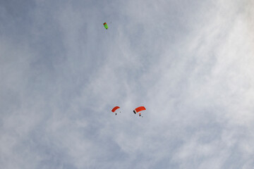 Tandem paraglider pilots with a slightly cloudy sky in Illertissen