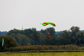 Tandem paraglider pilots with a slightly cloudy sky in Illertissen