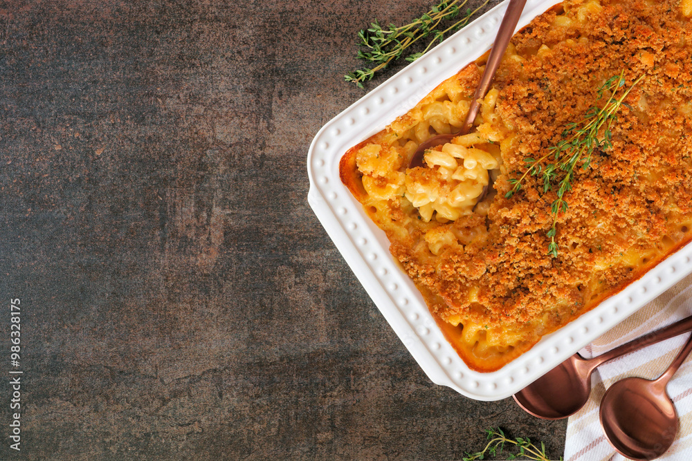 Poster traditional homemade macaroni and cheese casserole. above view table scene on a dark stone backgroun