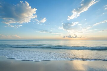 Fototapeta premium Peaceful Ocean Sunset with Blue Sky and Clouds