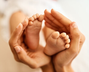 Baby, feet and mother hands for care, bonding and development with support, love and motherhood in home. Newborn, family and woman for connection, growth and nurture with protection, playing or trust