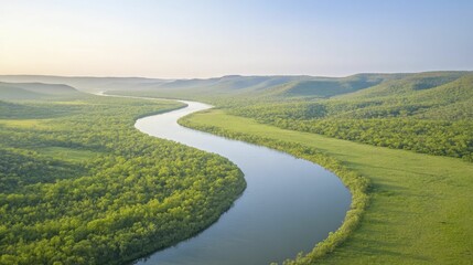 Serene River Flowing Through Lush Green Valley Surrounded by Rolling Hills Under Clear Blue Sky, Capturing the Beauty of Natures Tranquility and Wilderness