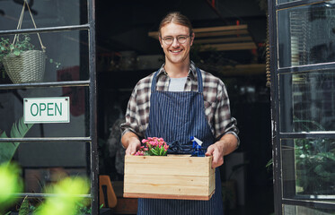 Man, portrait and open sign at flower store, small business and owner for plant nursery at entrance. Male person, retail manager and board in window for service, professional and pride in Scotland