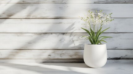 A minimalist arrangement featuring a white flower pot with delicate flowers against a wooden backdrop.