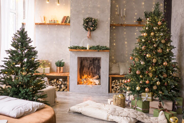 The interior of the Scandinavian-style living room, decorated for the Christmas holidays. Christmas tree next to the fireplace.