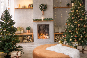 The interior of the Scandinavian-style living room, decorated for the Christmas holidays. Christmas tree next to the fireplace.