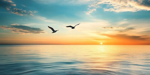 Fototapeta premium Seagulls Flying Over Calm Ocean During Sunset