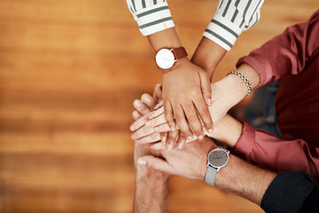 Business people, hands together or stack above with team for mission, collaboration or celebration at office. Top view, employees or huddle and piling for unity, solidarity or motivation at workplace