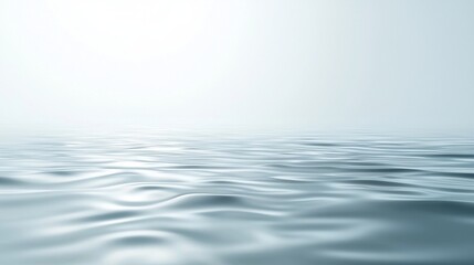 Obraz premium Gentle waves rippling on a vast ocean under a clear blue sky, creating a peaceful atmosphere with sunlight reflecting off the water. Perfect for a calm day outdoors