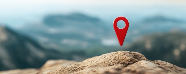Red location pin on a rock with blurred natural background in a travel setting.