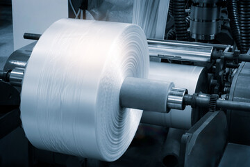 Close-up of the roller of the plastic bag production machine in the light blue scene. product...