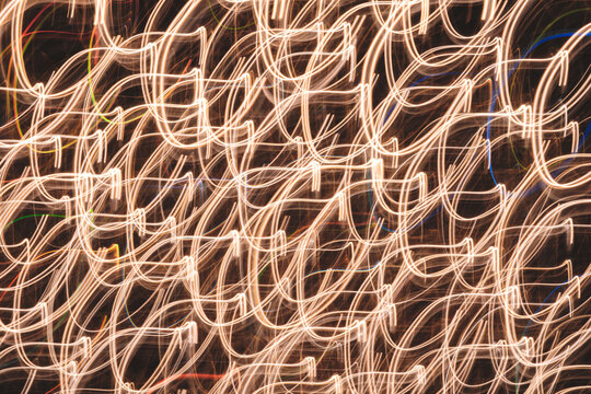  image is a blurry, colorful, and abstract representation of a pattern. The colors are bright and the lines are wavy, giving the impression of movement and energy. Scene is dynamic and lively