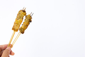 A photo of some chicken satay. This chicken satay originating from Cilacap, Central Java, Indonesia. its larger and thicker pieces of chicken compared to traditional satay, making it a unique culinary