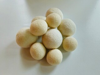 Closeup of sheep wool dryer balls for laundry isolated on white background