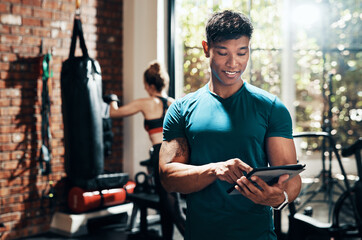 Man, tablet and smile in gym, personal trainer and record of information, client and practice of boxing. Health club, sports and endurance of boxer, people and workout for wellness and digital