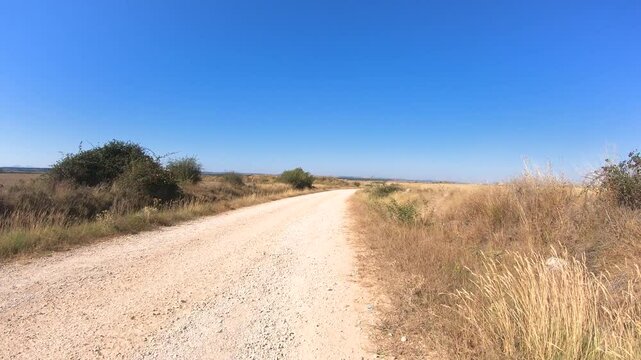 French Way of Saint James - a gravel road after Alto de Atapuerca, province of Burgos, Castile and Leon, Spain 