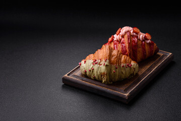 Crispy sweet red croissant with pistachio, raspberry and strawberry