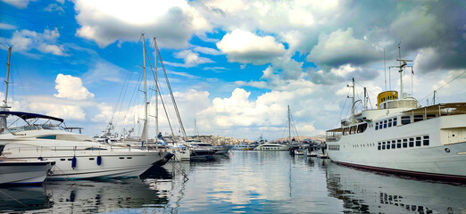 Photo of numerous luxury private yachts docked at Marina Flisvos in Palaio Faliro in a cloudy...