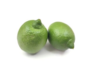 Photo of two fresh citrus lime fruits, isolated on white background.