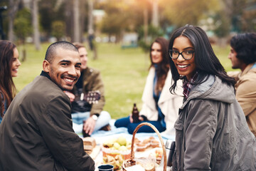 Friends, portrait and outdoor picnic at park, diversity and together for bonding in countryside. Happy people, grass and support on trip to Rio de Janeiro, food and travel group on weekend holiday