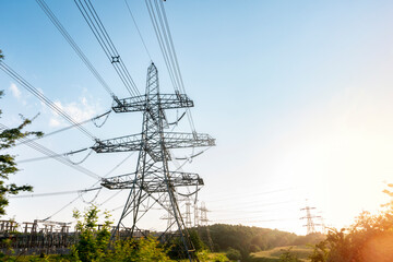 Power Lines Stretch Across Sunset Landscape, Capturing Interplay of Nature and Technology
