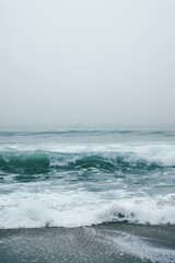 Fototapeta premium Ocean Waves Crashing on a Sandy Beach