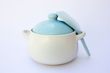 A porridge bowl and porridge spoon isolated on a white background. The tableware is made of porcelain and is colored blue and white.