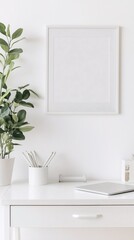 blank photo frame mockup on white wall with minimal white desk and plants decorating