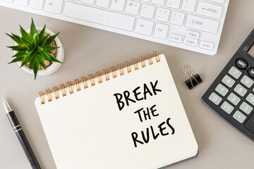 Break the rules, conceptual words written in a notebook on a desk in the office, unconventional...